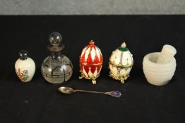 Two 20th century gilt and enamel egg ornaments, together with a small glass globular scent bottle