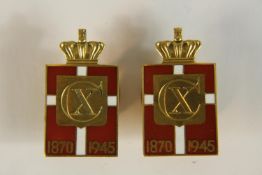 A pair of 14 carat gold and red and white enamel commemorative lapel badges by Georg Jensen for