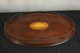 An Edwardian oval inlaid mahogany and brass gallery tray inset with inlaid shell decoration,