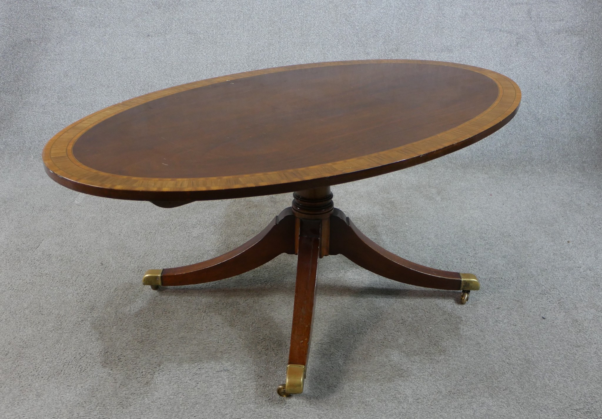 A Regency style inlaid mahogany oval coffee table raised on turned central column on four outswept - Image 5 of 6