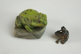 A pair of mating silver frogs along with a painted pewter frog on a rock. H.4cm. (largest)