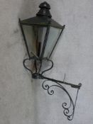 A painted wrought iron Victorian style wall mounted lamp (converted to electricity) H.145 W.75 D.