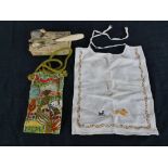 A 19th/ early 20th century sewing kit, together with an embroidered bag and a child's bib. H.27 W.