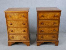 A pair of 20th century burr walnut veneered four drawer chest of drawers with turned knob handles