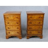 A pair of 20th century burr walnut veneered four drawer chest of drawers with turned knob handles