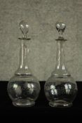 A pair of early 19th century glass decanters and stoppers each etched with grape and vine