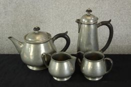 A 20th century Liberty & Co hammered pewter four piece tea and coffee set comprised of teapot,