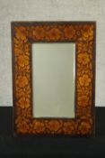 A late 19th/early 20th century beech pokerwork rectangular wall mirror with leaf and flower