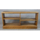 An early 20th century oak four shelf open bookcase raised on plinth base. H.71 W.147 D.33cm