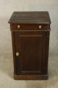 A 19th/early 20th century stained single door wash stand, the hinged lid opening to reveal a white