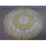 A 20th century yellow ground Chinese circular carpet, embroidered with floral decoration. W.186 D.