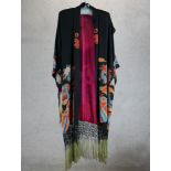 A 20th century Japanese embroidered silk kimono with tassel edging. H.136 W.44cm