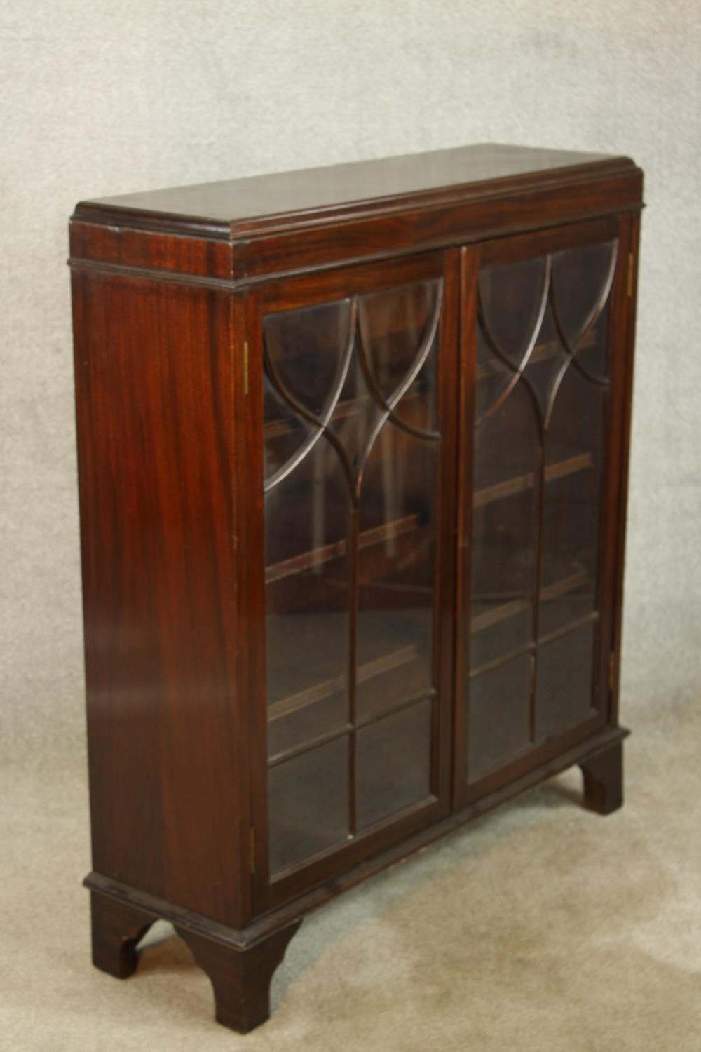An early 20th century mahogany two door door display cabinet raised on shaped bracket feet. H.107 W. - Image 4 of 7
