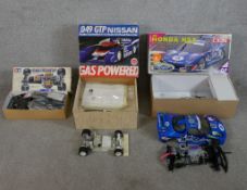Three boxed scale model cars to include Tamiya 1:10 F103RS Chassis kit, Nissan 93 Cox racing car &