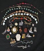 A collection of costume jewellery, including venetian foil necklaces, French paste jewellery and