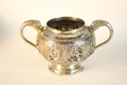 An Indian white metal (tests as silver) twin handled repousse sugar bowl with elephant head