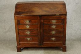 A 19th century mahogany fall front bureau opening to reveal fitted interior with two cupboard