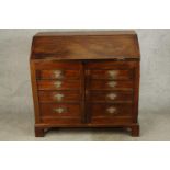 A 19th century mahogany fall front bureau opening to reveal fitted interior with two cupboard