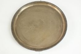 An Elizabeth II hallmarked silver circular salver, London 1989 with beaded rim and raised on four