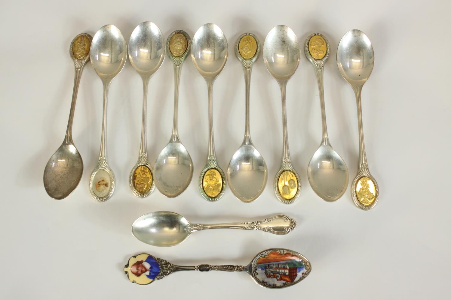 A set of nine Elizabeth II hallmarked silver gilt floral design tea spoons by Robert Chandler,