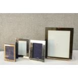 A pair of silver plated rectangular photograph frames, together with two other silver plated