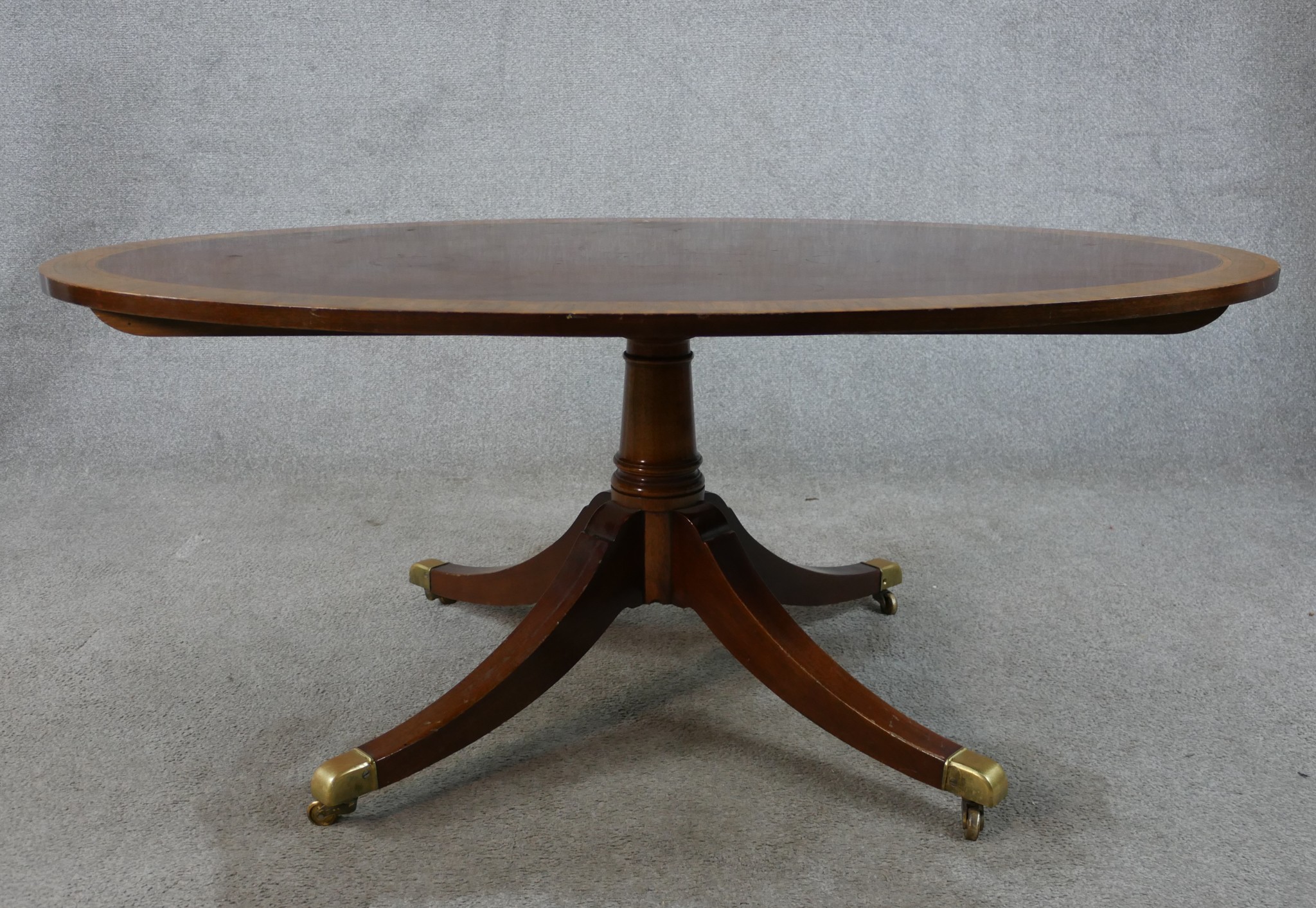 A Regency style inlaid mahogany oval coffee table raised on turned central column on four outswept - Image 2 of 6
