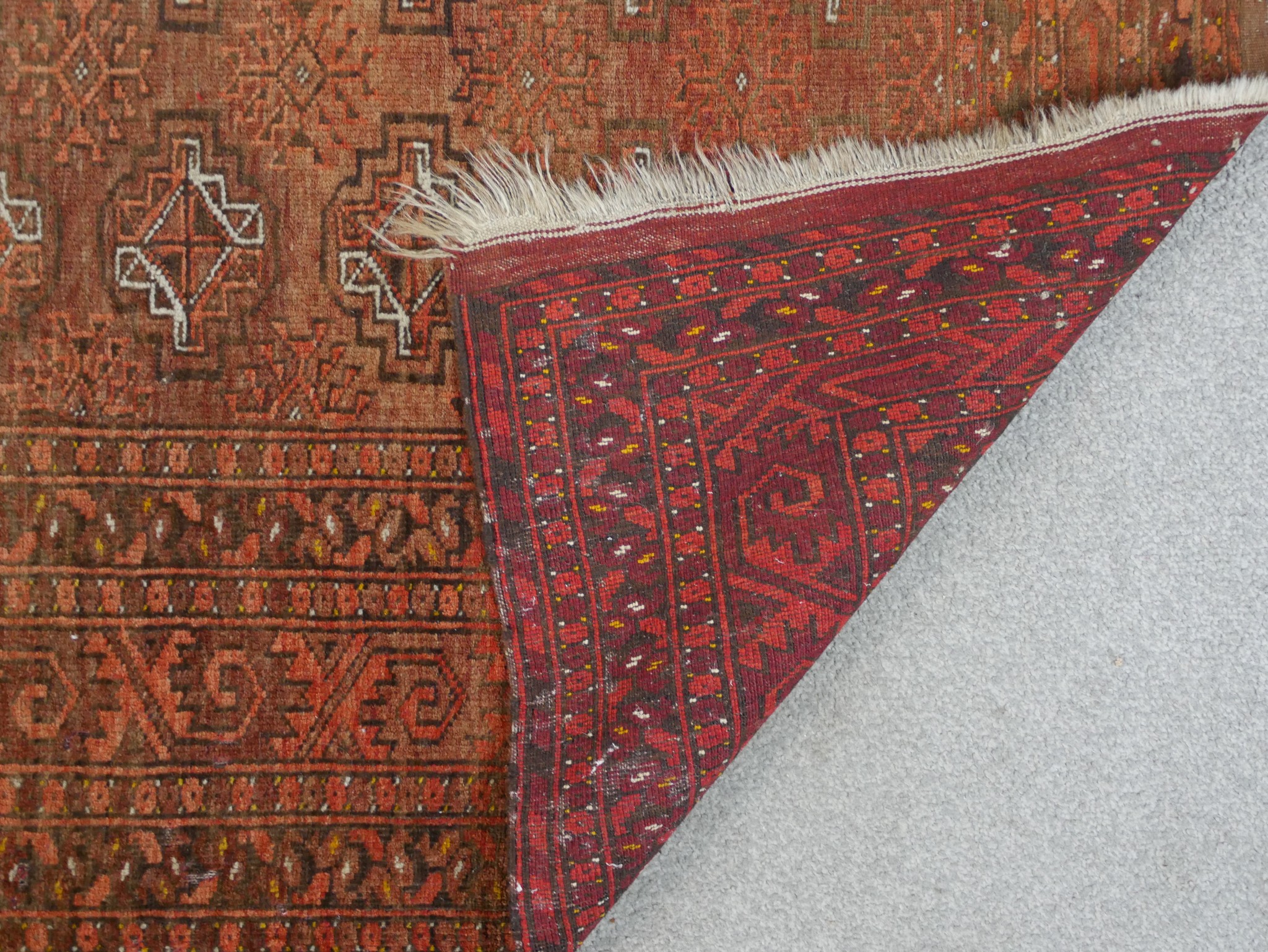 A 20th century Persian orange ground woollen rug with lozenge design within geometric border. H. - Image 4 of 4