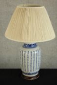 A contemporary Chinese blue and white table lamp decorated with Chinese calligraphy raised on