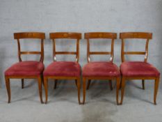 A set of four Regency style mahogany framed bar back chairs raised on cabriole supports, with