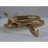 A Victorian style vintage 9ct gold sprung snake bangle (Expands). The snake's head engraved