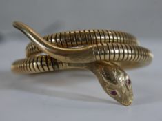 A Victorian style vintage 9ct gold sprung snake bangle (Expands). The snake's head engraved