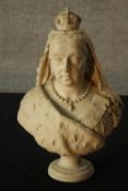 A 19th century carved white hardstone, possibly marble bust of Queen Victoria, raised on turned