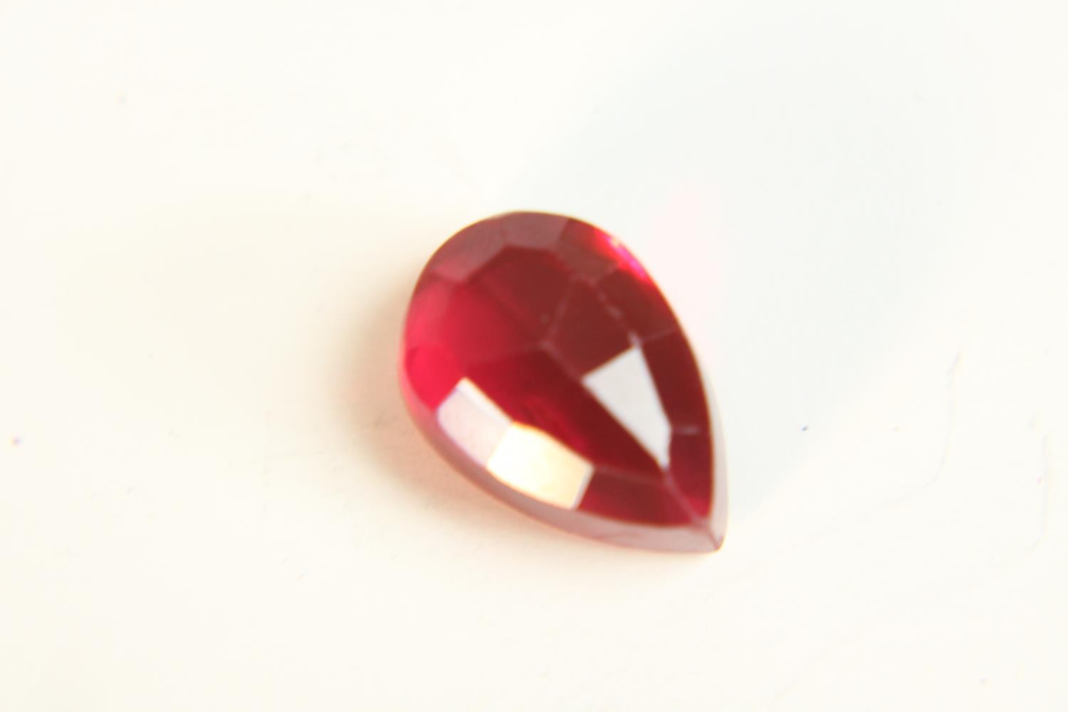 A 12.57 carat mixed cut pear shaped ruby. - Image 9 of 10