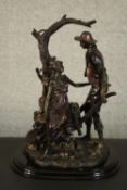 A Leonardo Collection bronze resin figure group of a young couple with a wheelbarrow under a tree.