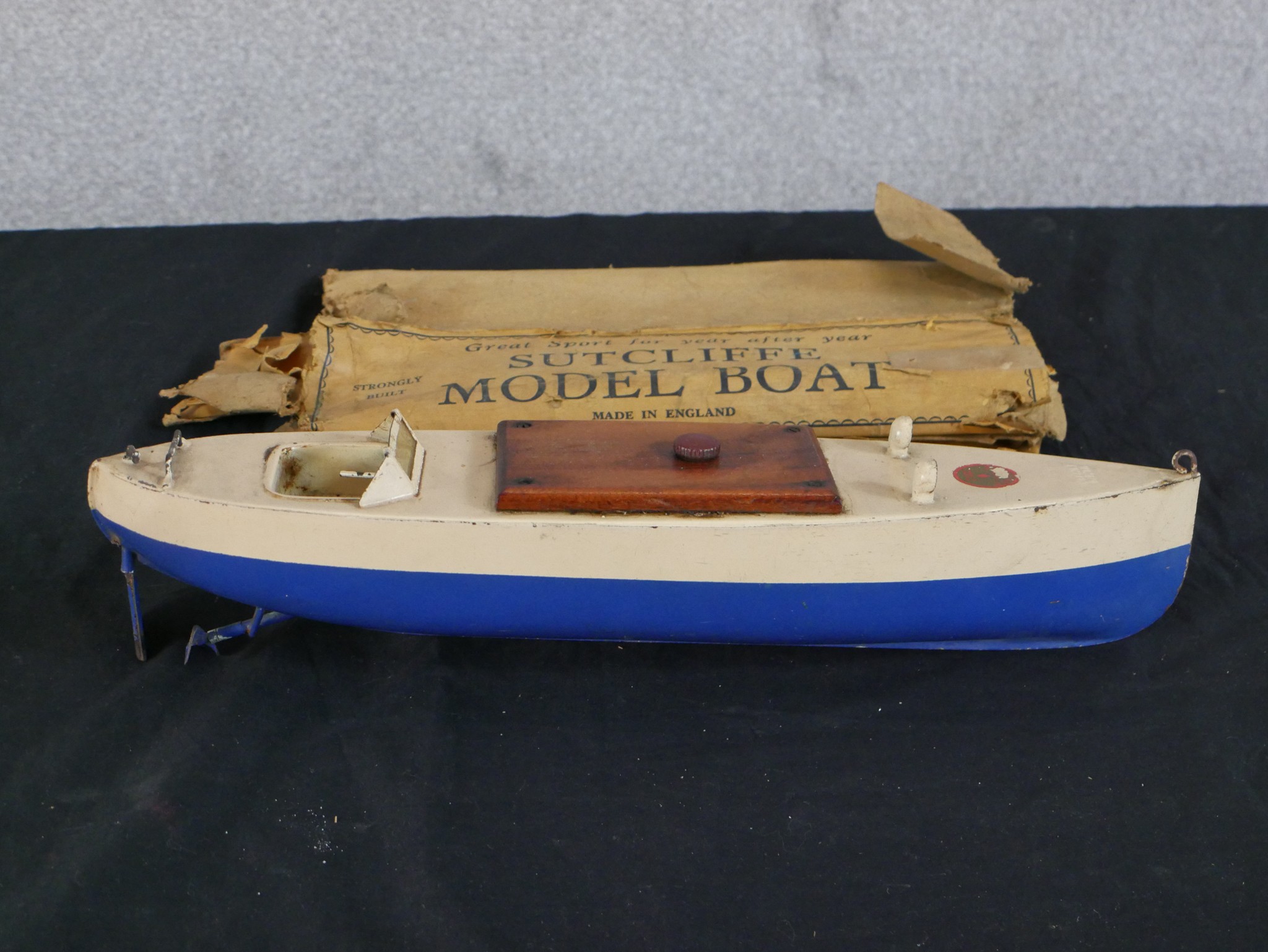 A 20th century boxed Sutcliffe painted model boat. H.9 W.41 D.10cm