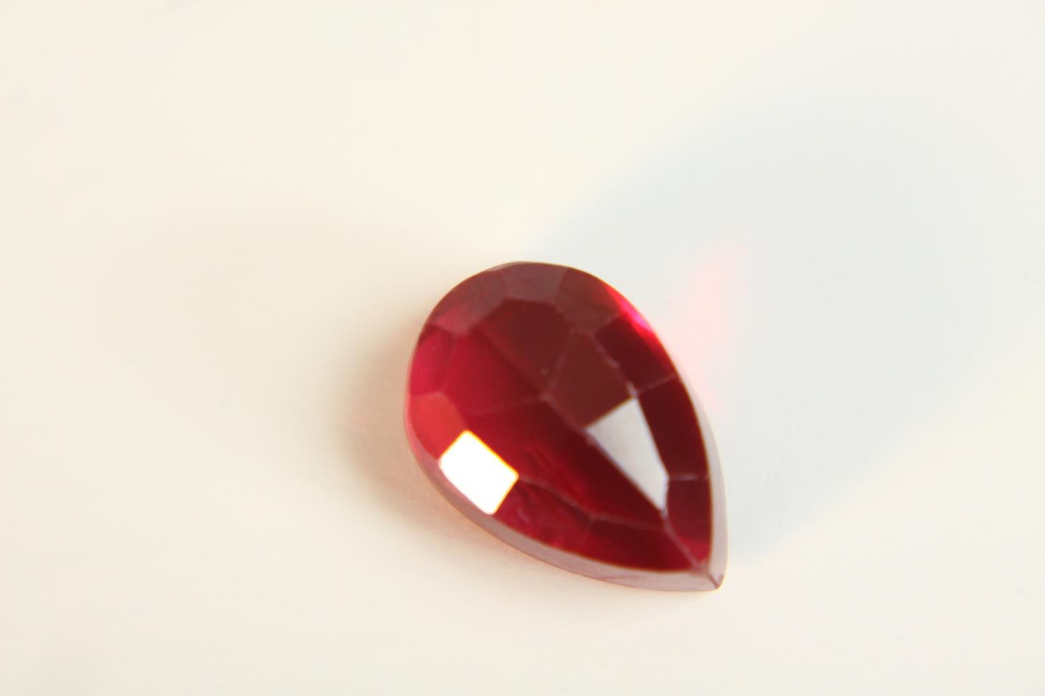 A 12.57 carat mixed cut pear shaped ruby. - Image 10 of 10