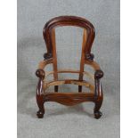 A 19th century mahogany framed child's open arm chair raised on cabriole supports terminating in