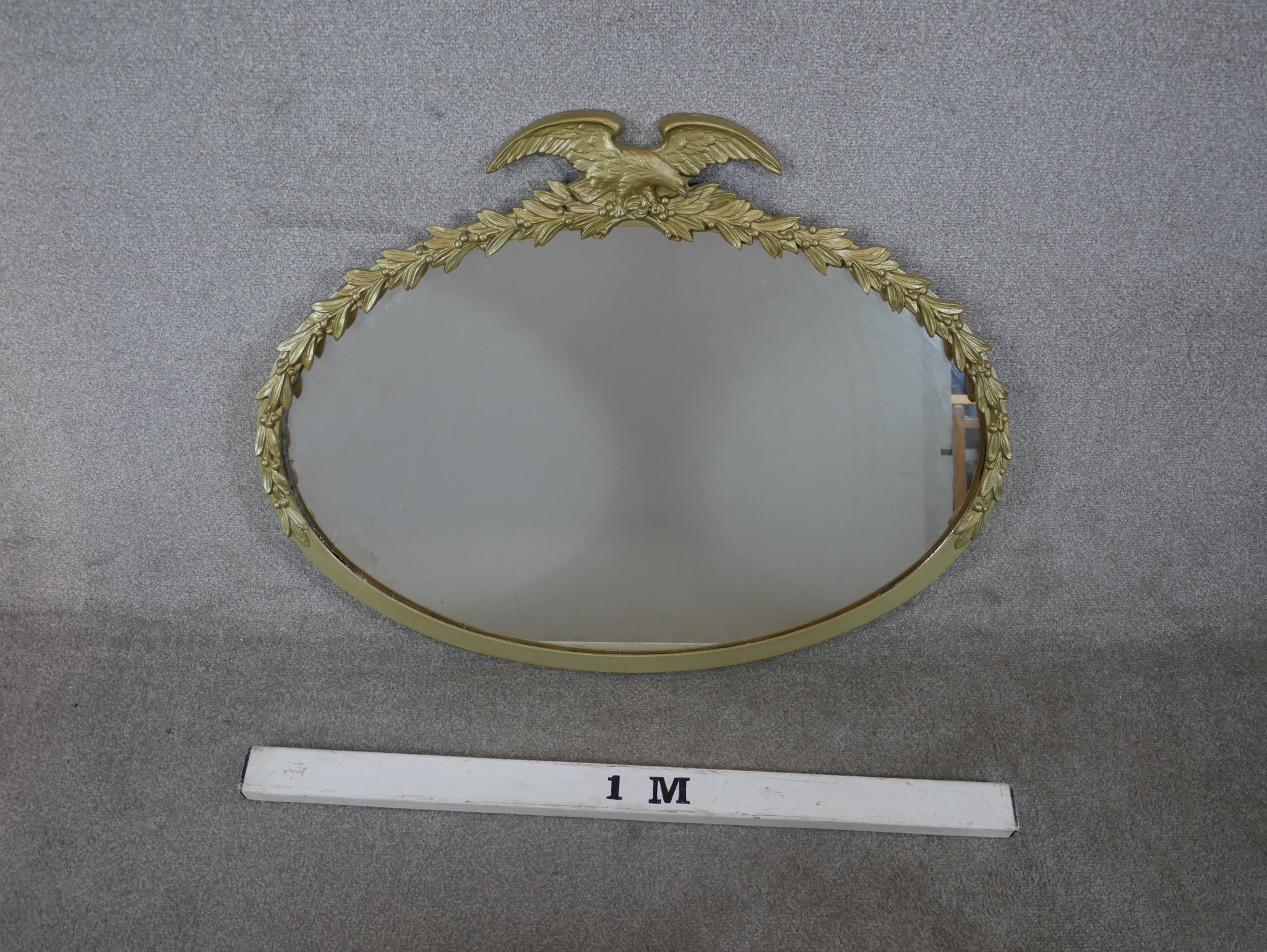 A 20th century oval gilt framed mirror mounted with leaf and eagle decoration. H.77 W.96cm - Image 2 of 3