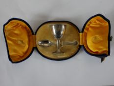 A late Victorian matching cased hallmarked silver egg cup and teaspoon, London 1897.H.7 W.13 D.11cm,