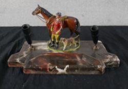 An Art Deco marble desk stand/pen stand mounted with a painted horse and rider. H.14 W.27 D.24cm