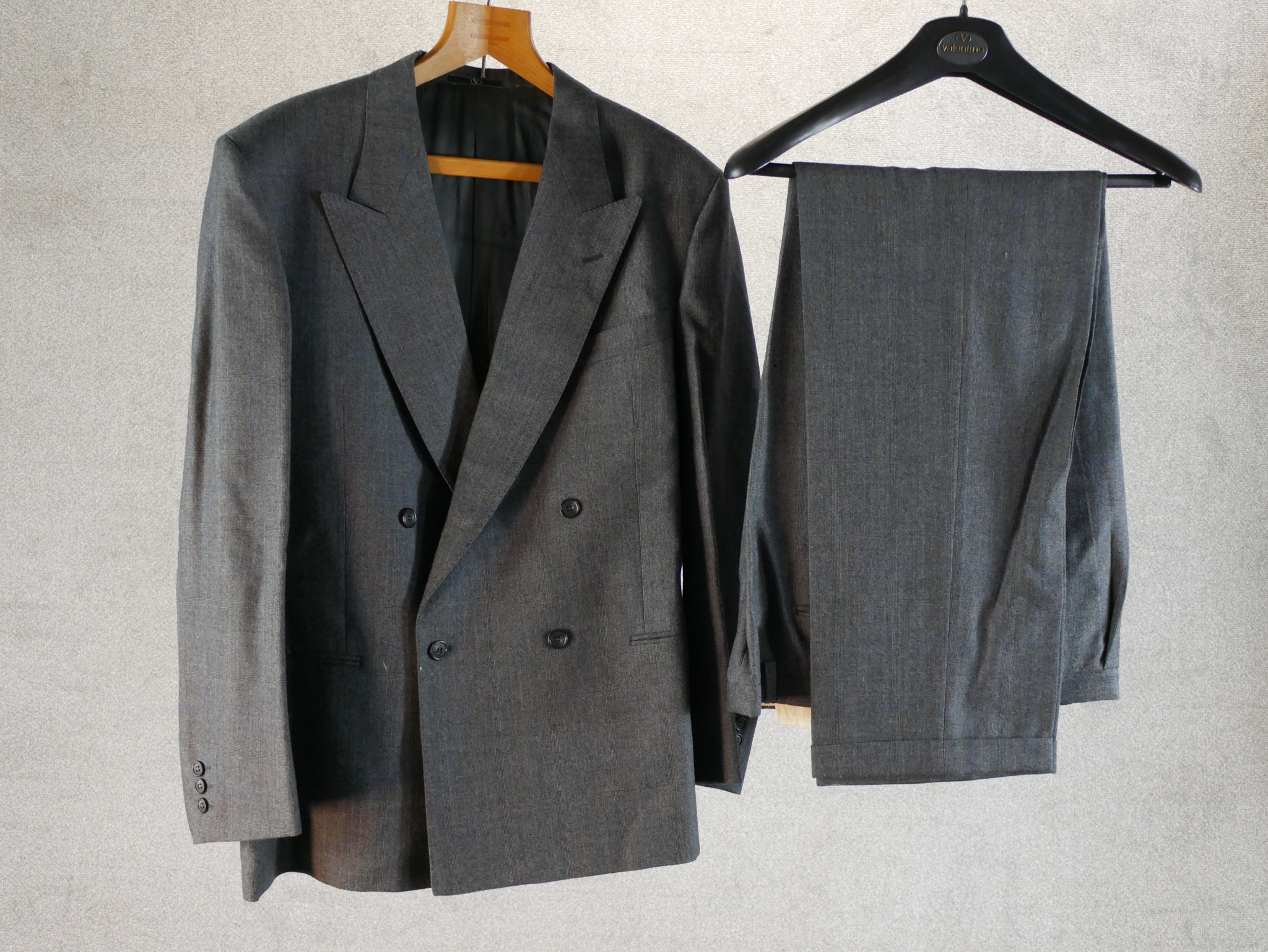 A Valentino handmade custom two piece grey suit comprised of a double breasted jacket and a pair