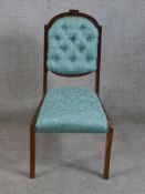 A 19th/early 20th century mahogany framed blue damask button back child's chair raised on sabre styl