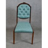 A 19th/early 20th century mahogany framed blue damask button back child's chair raised on sabre styl