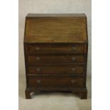 An early 20th century stained mahogany bureau, the fall front opening to reveal fitted interior,