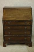 An early 20th century stained mahogany bureau, the fall front opening to reveal fitted interior,