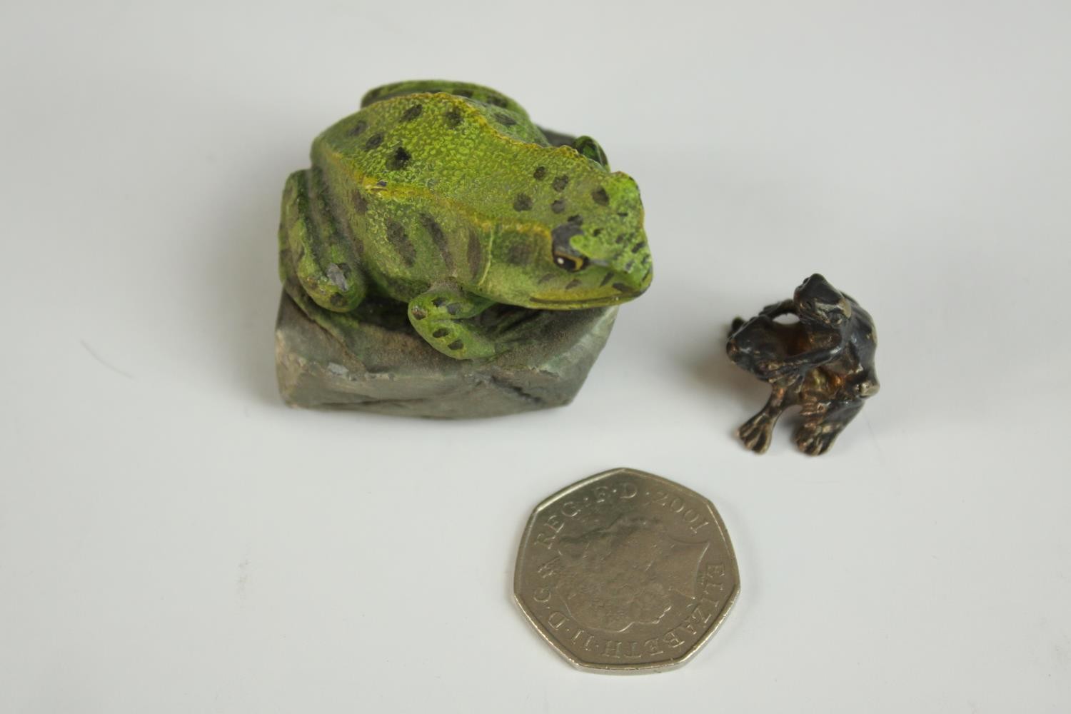 A pair of mating silver frogs along with a painted pewter frog on a rock. H.4cm. (largest) - Image 2 of 11