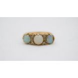 A vintage three stone carved half hoop 18 carat yellow gold opal and diamond ring. Set with three