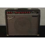 A 20th century Fender electric guitar amp with pedal switch. H.44 W.52 D.23cm.