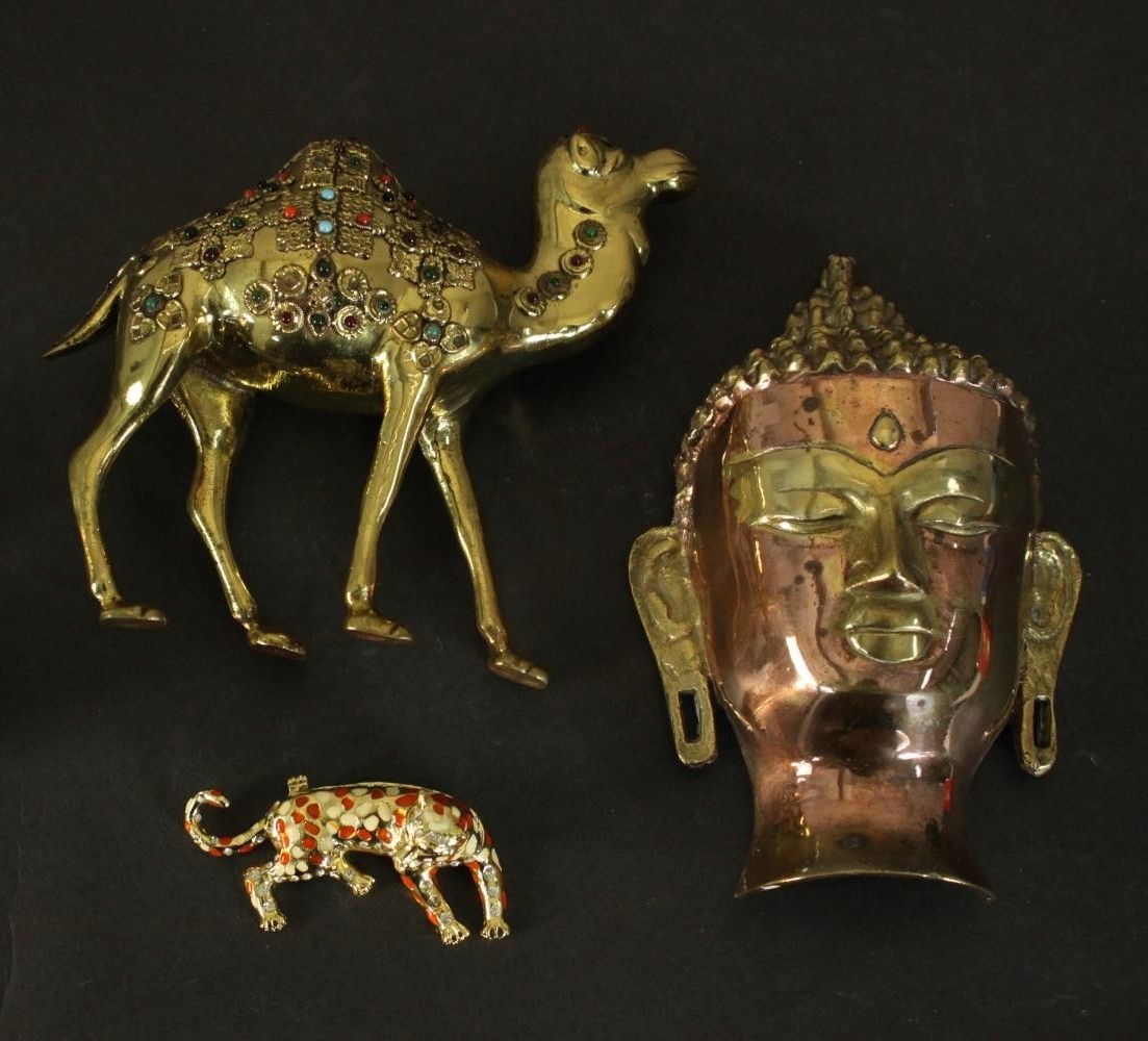 A collection of metal work items, a copper and brass Buddha head, a glass cabochon inlaid brass