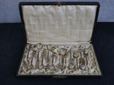 A cased set of ten Continental silver teaspoons, together with matching silver sugar shovel. 130g